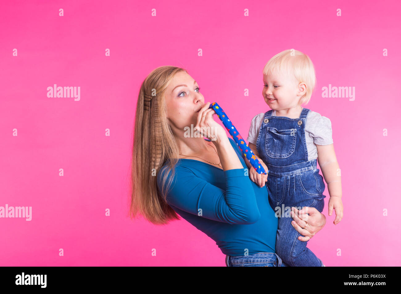 Funny family on pink background. Mother and her daughter girl. Mom and ...