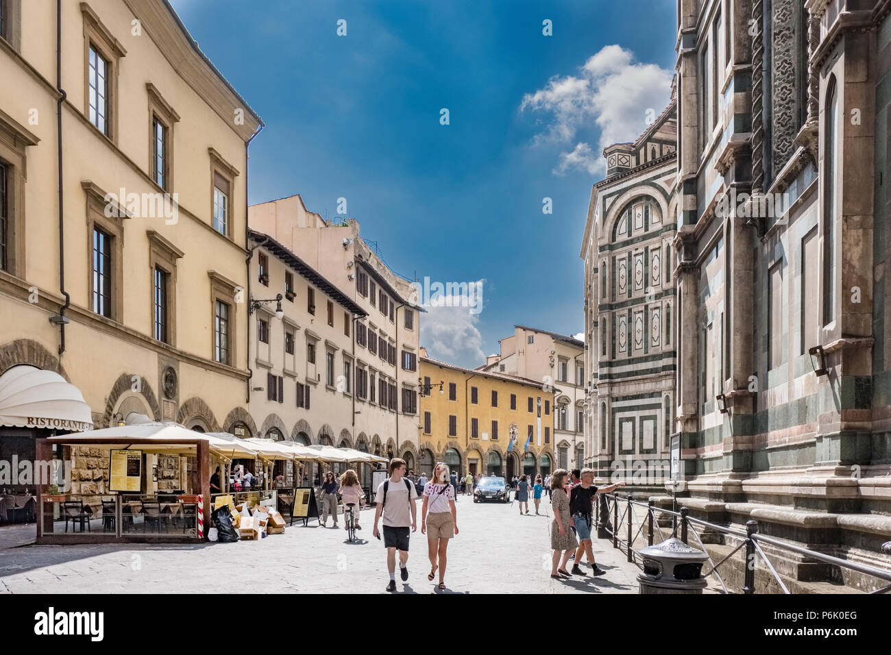 Florence, Italy. June 1, 2018: Plaza del Duomo with terraces of bars with terrace bars with umbrellas partial view of the side of the Cathedral of San Stock Photo