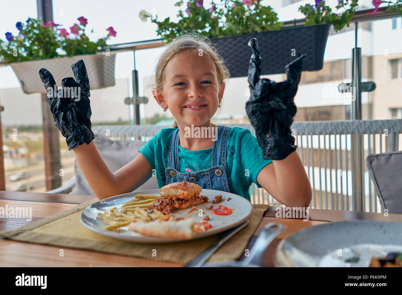child eats a Burger in a restaurant Stock Photo