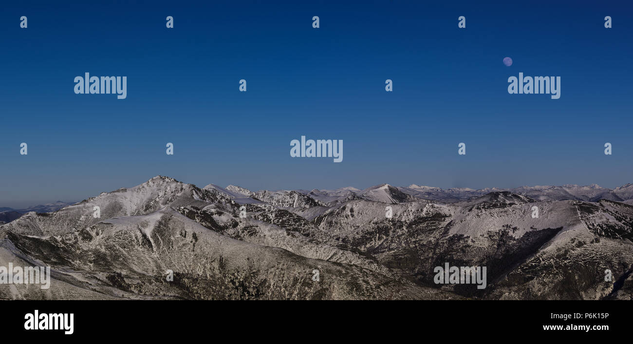 Full moon over the snowy mountains of Ancares, in Galicia Stock Photo