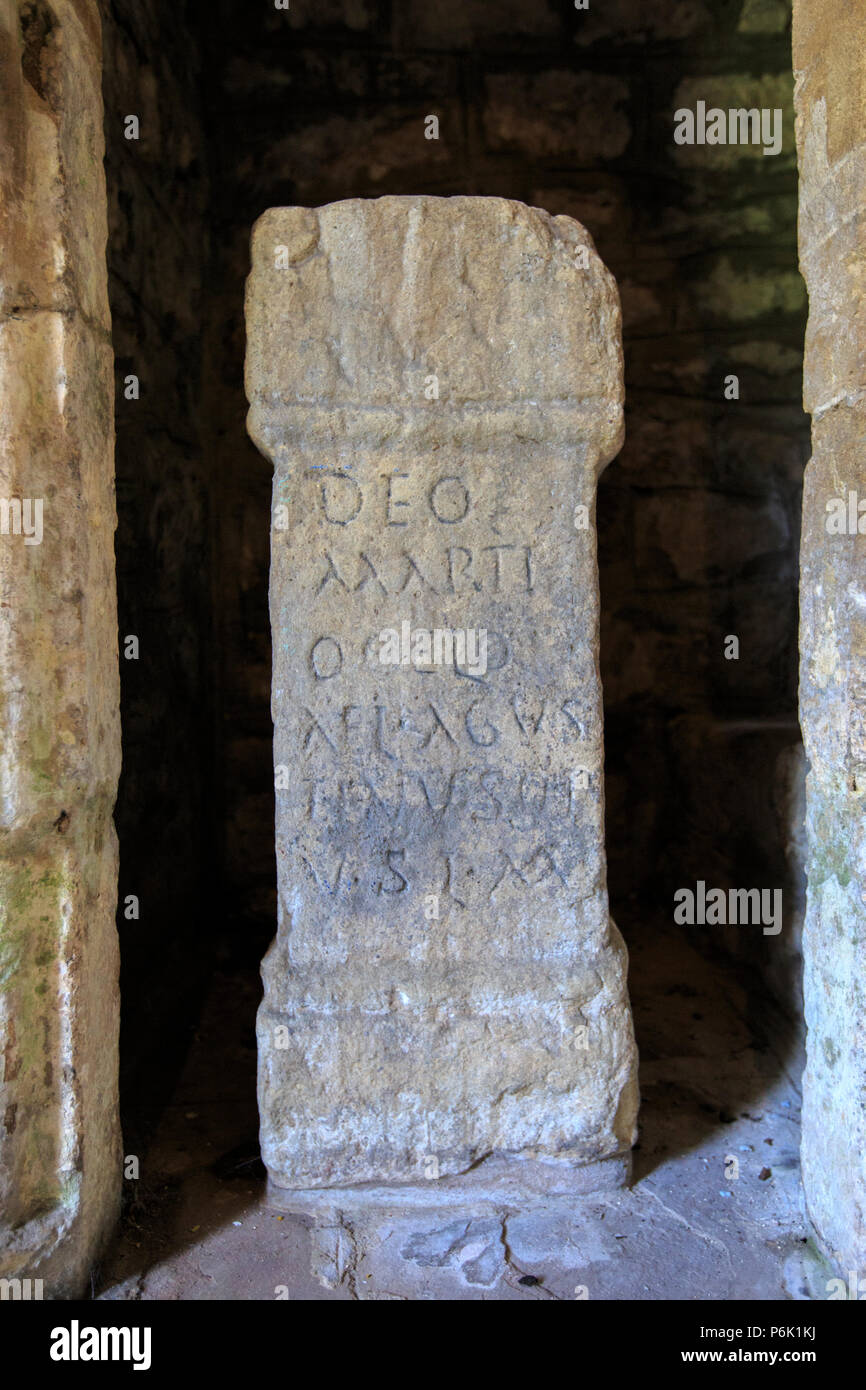 A Roman Altar Stone found at Caerwent and on display at the entrance to St Stephen & St Tathan Church, Caerwent, Wales Stock Photo