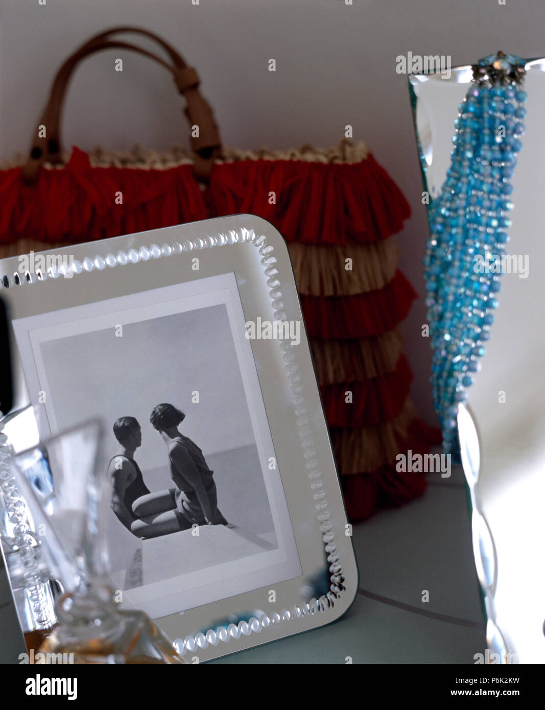 Close-up of a black+white photograph in a glass frame in front of a handbag Stock Photo