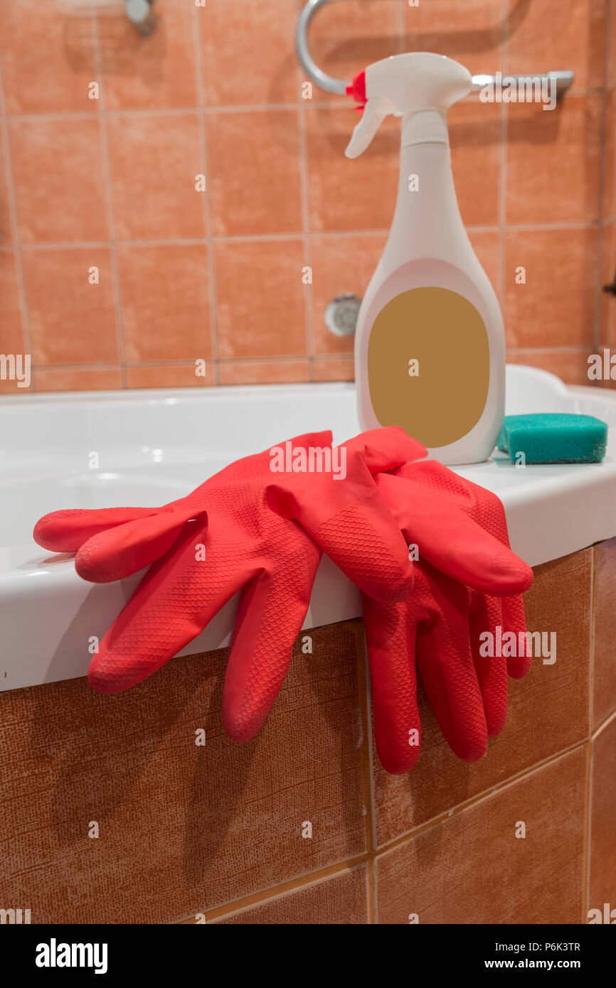 Hand protection: red latex household gloves and cleansing sponge. Stock Photo