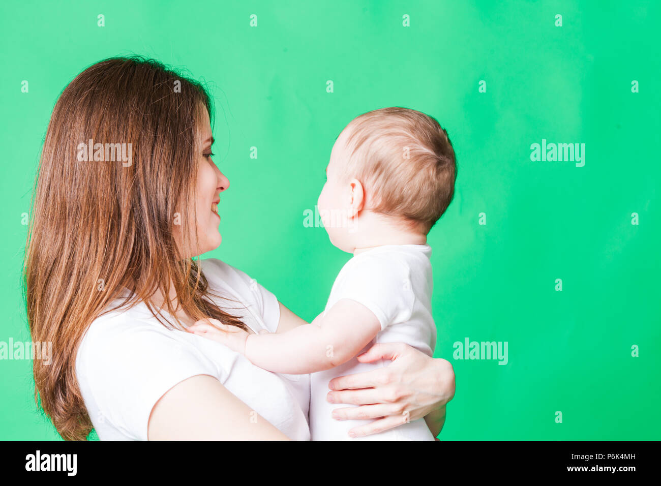 Pretty mother and her child looking at something Stock Photo - Alamy