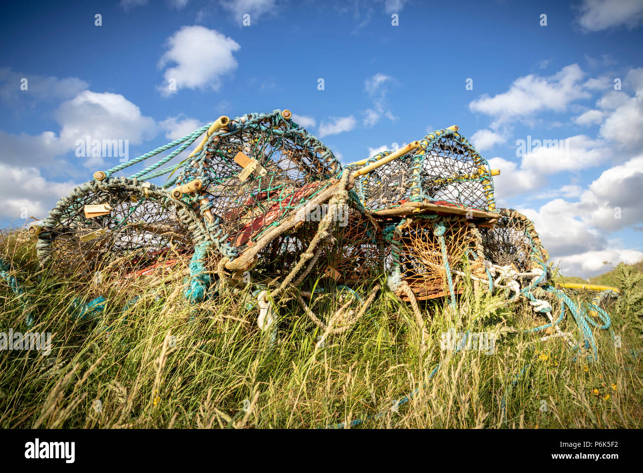 Stack of lobster pots on harbour side Stock Photo