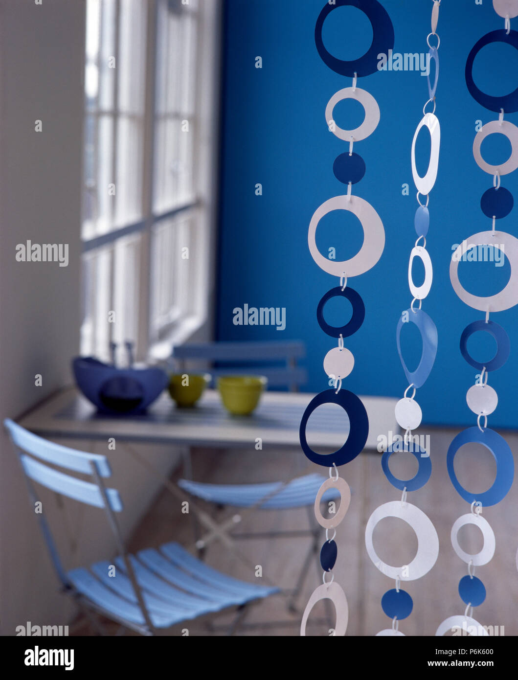Simple room divider made from white and blue circles in a blue economy