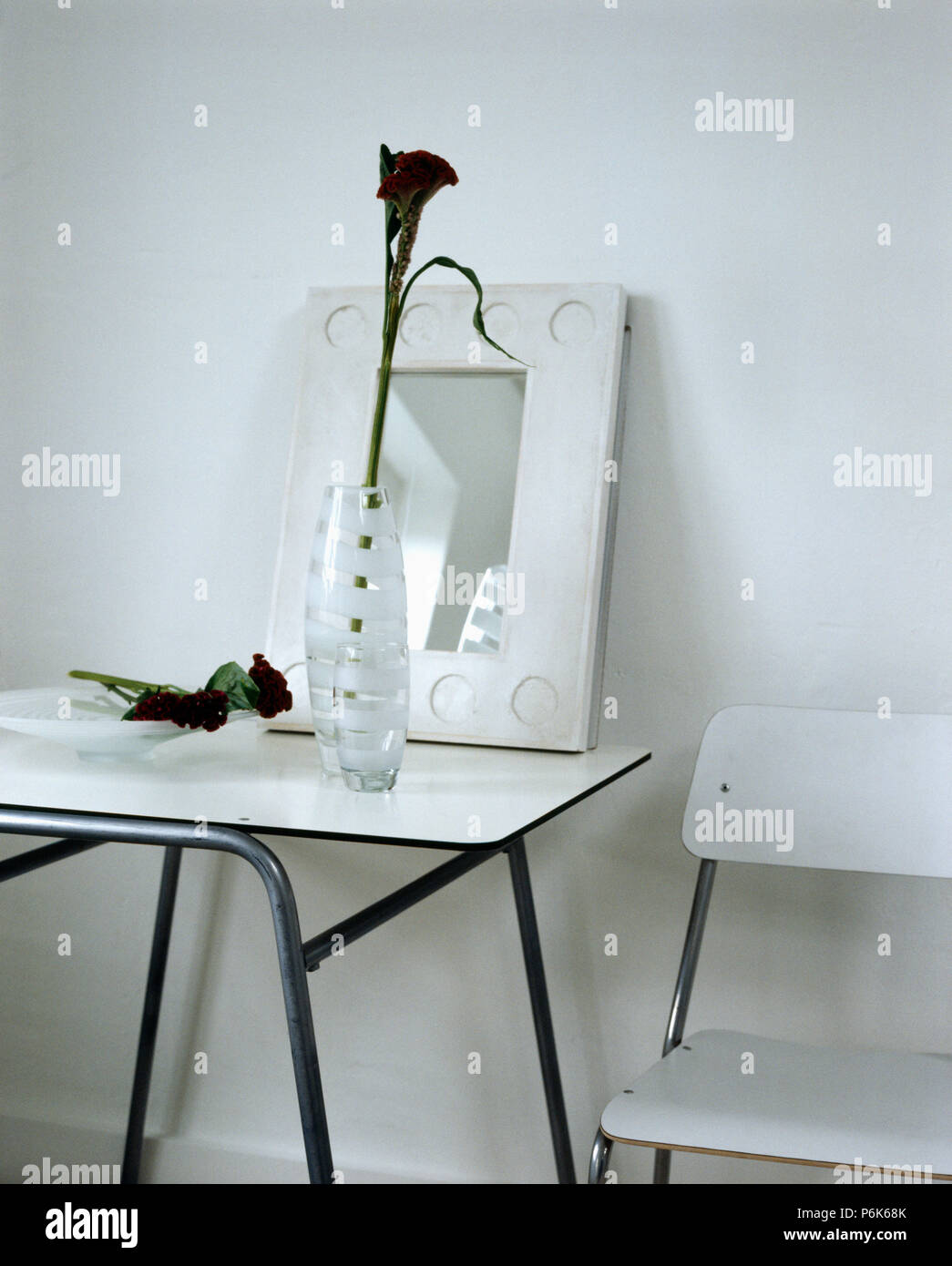 Mirror and glass vase on white trestle table in modern white dining ...