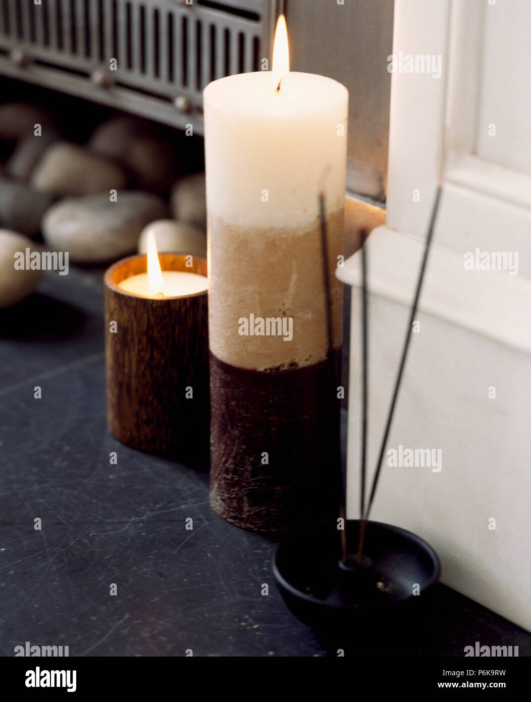 Close-up of cream pillar candles in wooden holders Stock Photo