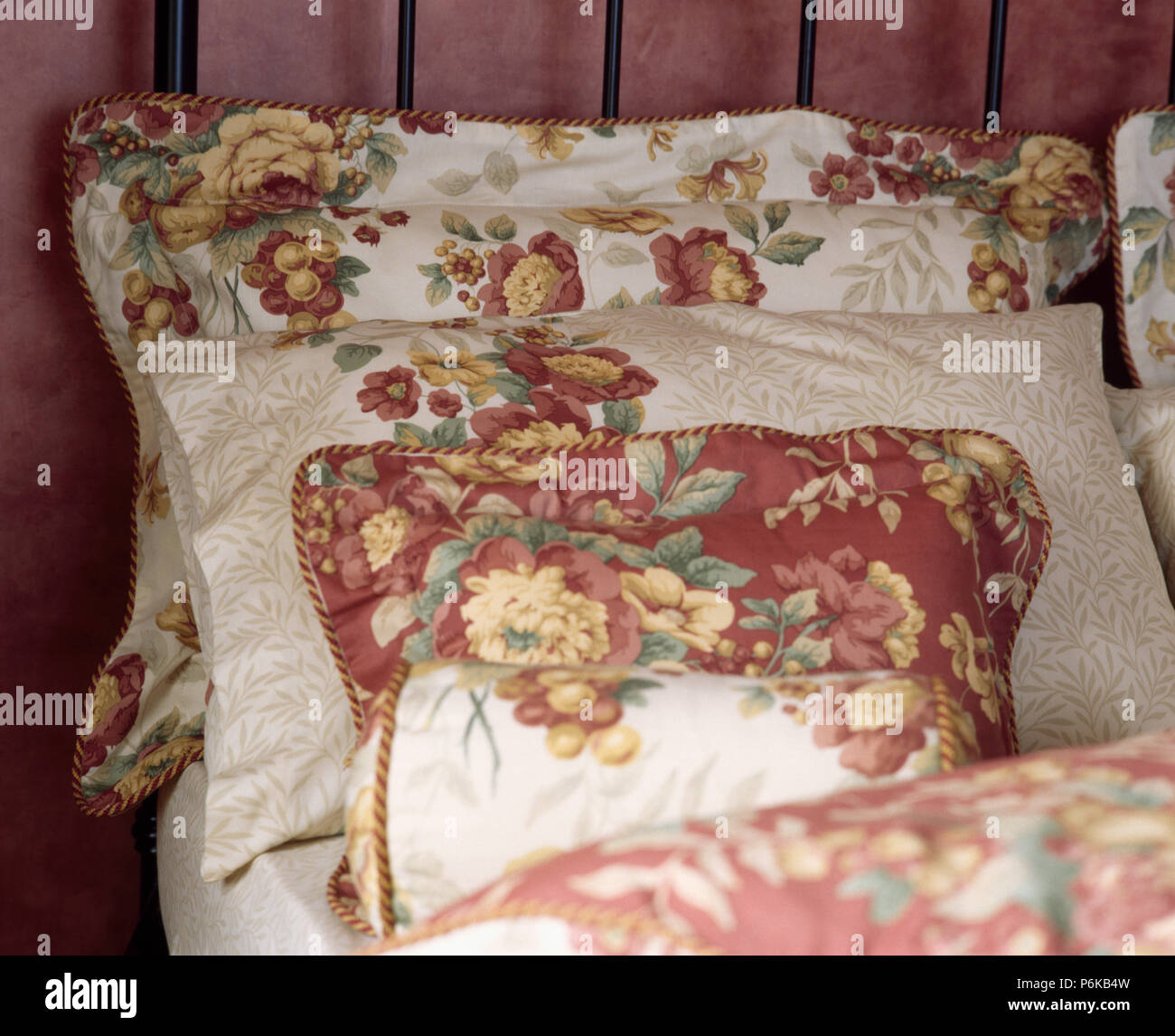 Close Up Of Dark Red Rose Patterned Cushions And Pillows Stock