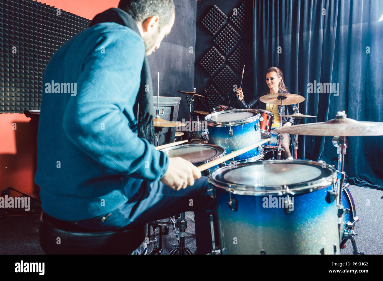 Woman receiving drum lessons from her music teacher Stock Photo