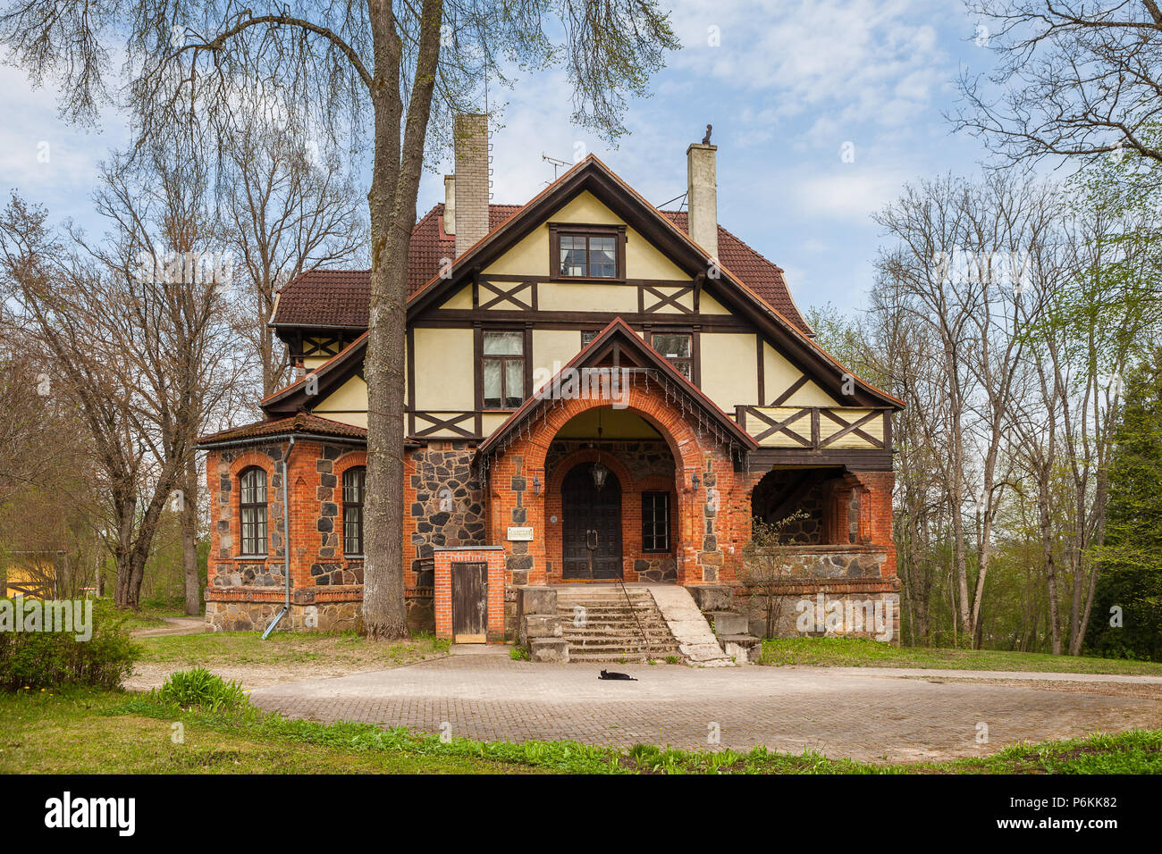 Stone house in Estonia, manor building decorated with granite. Summer time. Stock Photo