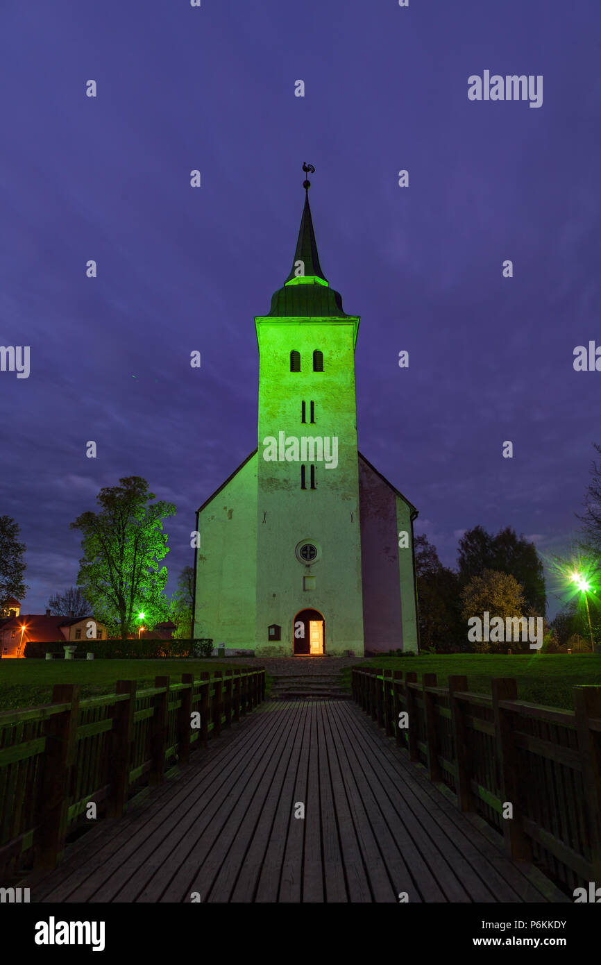 Beautiful bright green artificial light over church in Viljandi, Estonia. Stock Photo
