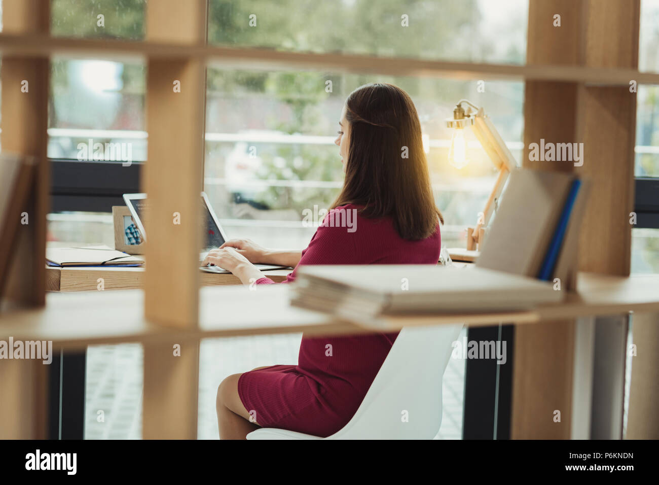 Professional secretary sitting at the table and working alone Stock ...