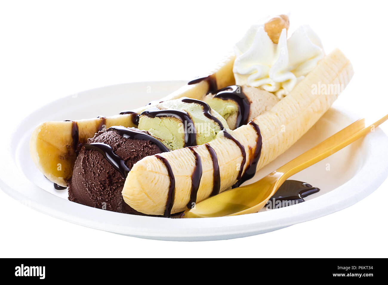 Banana split with pistachio hazelnut and chocolate ice cream garnished with chocolate syrup and whipped cream Stock Photo