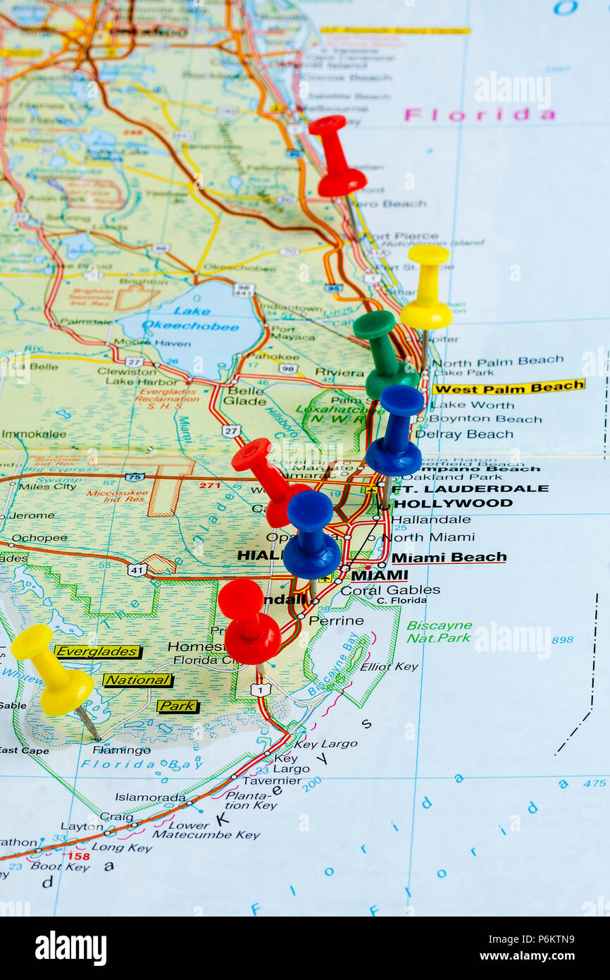 Multicolored Pushpins on Map Coast Stock Photo