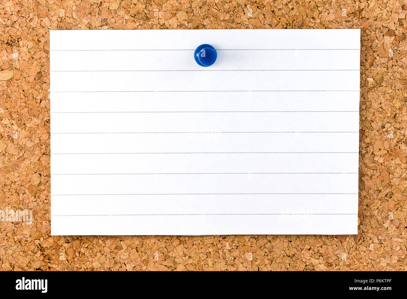 Horizontal Blank white striped sheet fixed on cork board with a blue small thumb tack Stock Photo