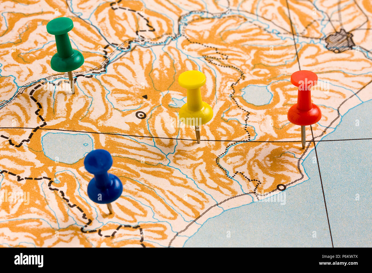 Multicolored Pushpins on Nameless Map Stock Photo