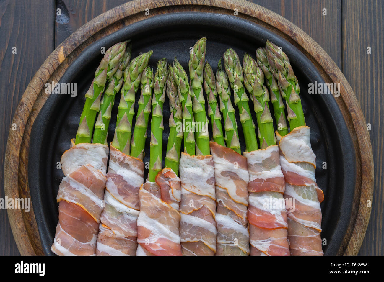 Asparagus wrapped in bacon on the hot pan Stock Photo Alamy