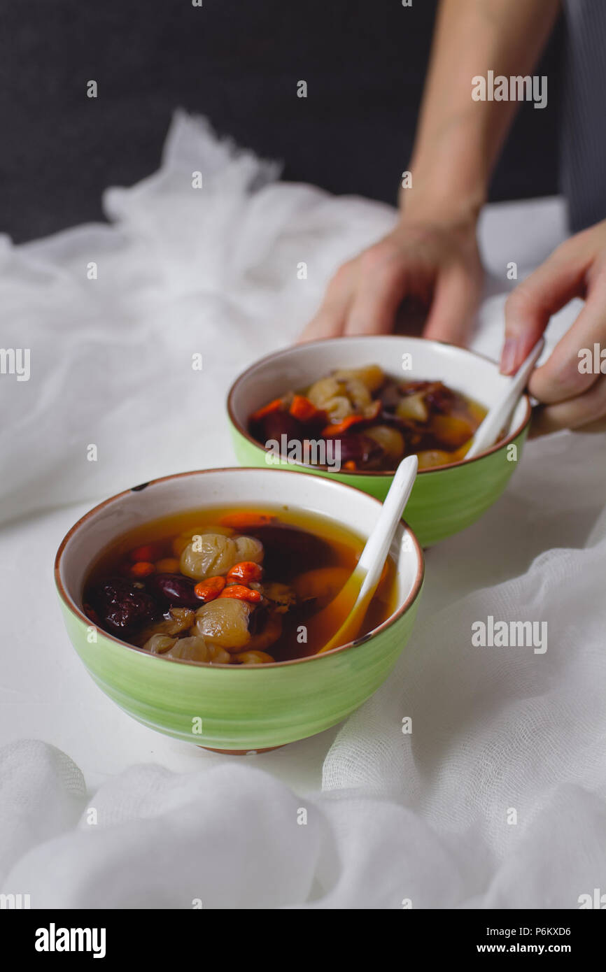 Red Date Longan Soup. Chinese dessert in green bowl. Two bowls Stock