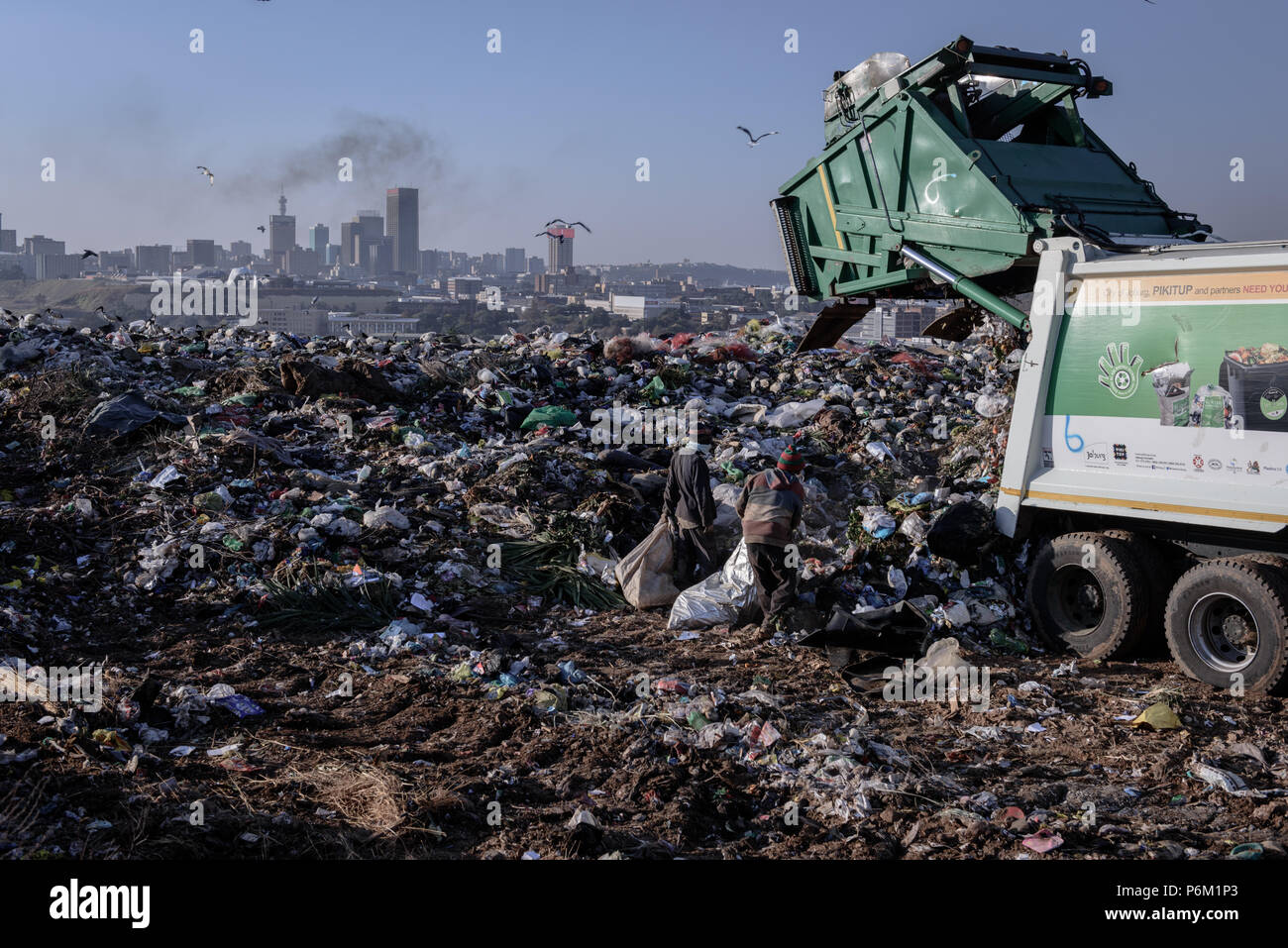 Rubbish pickers wait for a new load being deposited at Johannesburg's