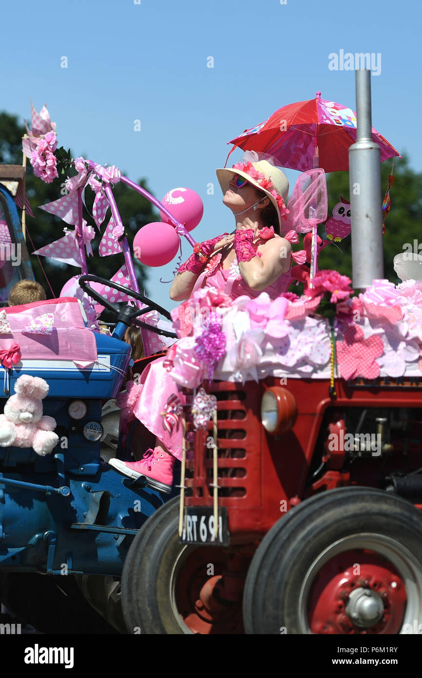 A lady applies sun cream before the start of the 15th Annual Pink Ladies Tractor Road Run in aid of Cancer Research UK at Thorpe Abbots airfield in Norfolk. Stock Photo