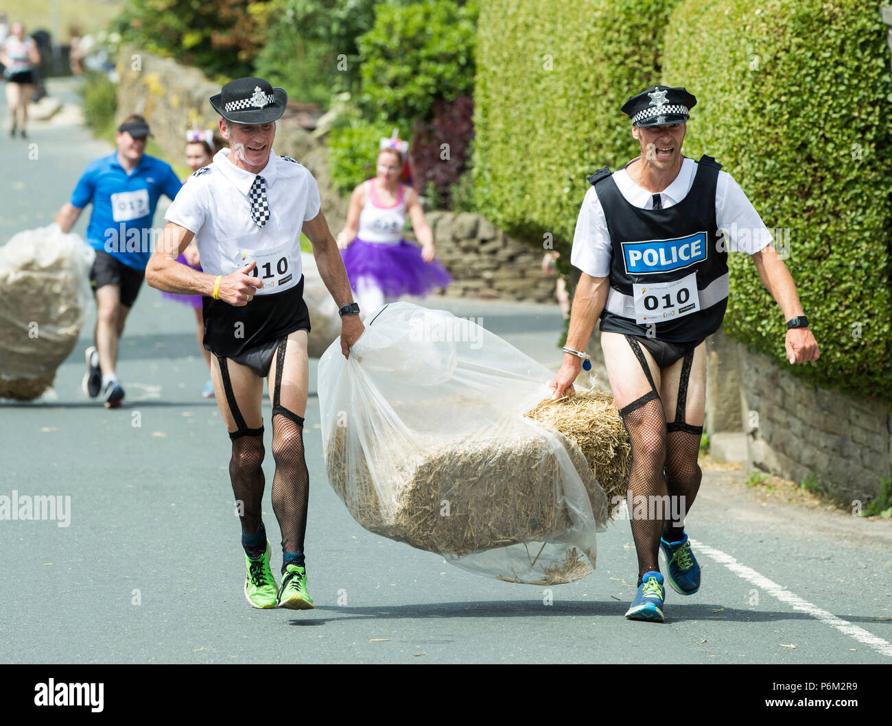 Competitors takes part on the Oxenhope Straw Race in Yorkshire, a 2.5