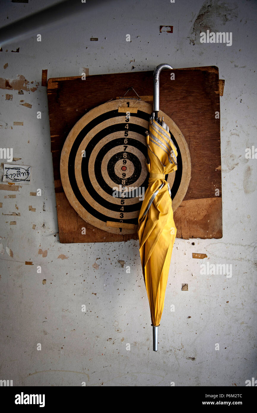 umbrella hanging on dart board Stock Photo