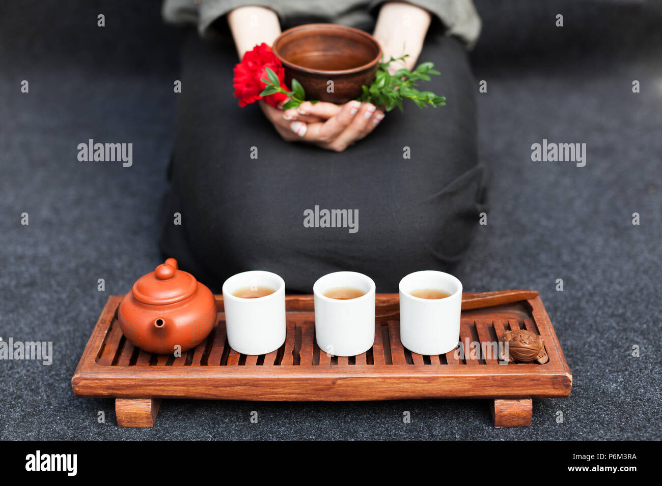 Herbal tea in a ceramic plate in female hands. The concept of nontraditional treatment of colds. Flu. Healthy Eating and Vitamins. Stock Photo