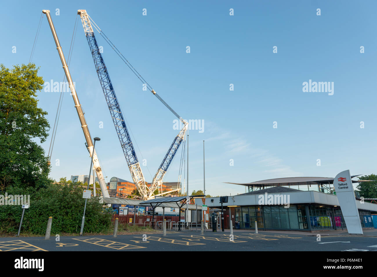 Telford Central Station, Telford, Shropshire, UK, Sunday July 1st 2018.  One of Europe's largest mobile cranes lifts a new section of railway footbridge into place over the railway line next to the A442 Queensway Road, Telford.  The 95 ton Liebherr LG1750 mobile crane lifed the first crossing section onto it's mounts in the early hours of Sunday morning 1st July 2018.  The civil engineering project is replacing the original footbridge at a cost of around £10 million. Credit: AMD Images/Alamy Live News Stock Photo