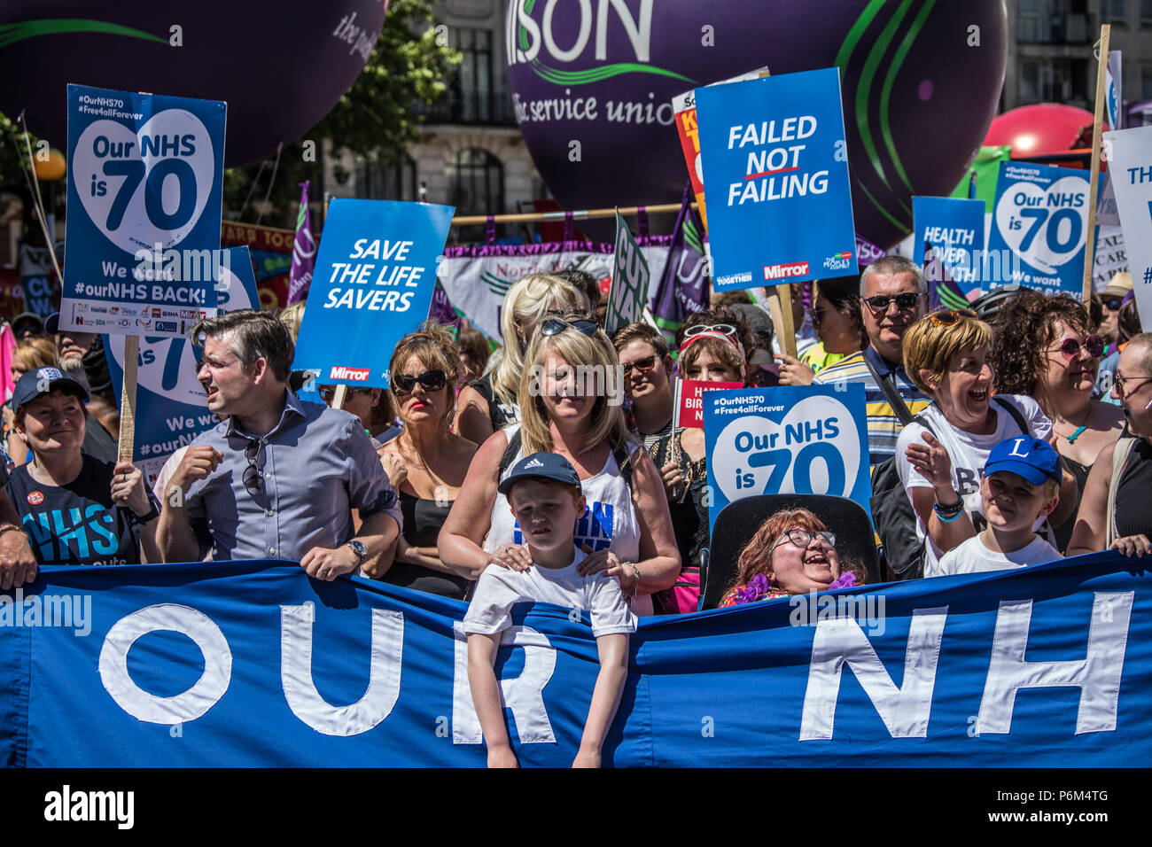 London, UK. 30th Jun, 2018. The head of the march. Jon Ashworth, Shadow Secretary of State for Health and Social Care , actress Sally Lindsay, musican Steve White and actress Julie Hesmondhalgh. With the NHS 70 years old this year, thousands marched through central London in a National rally to show support for the service and to demand more funding from the Government. David Rowe/Alamy Live News Stock Photo