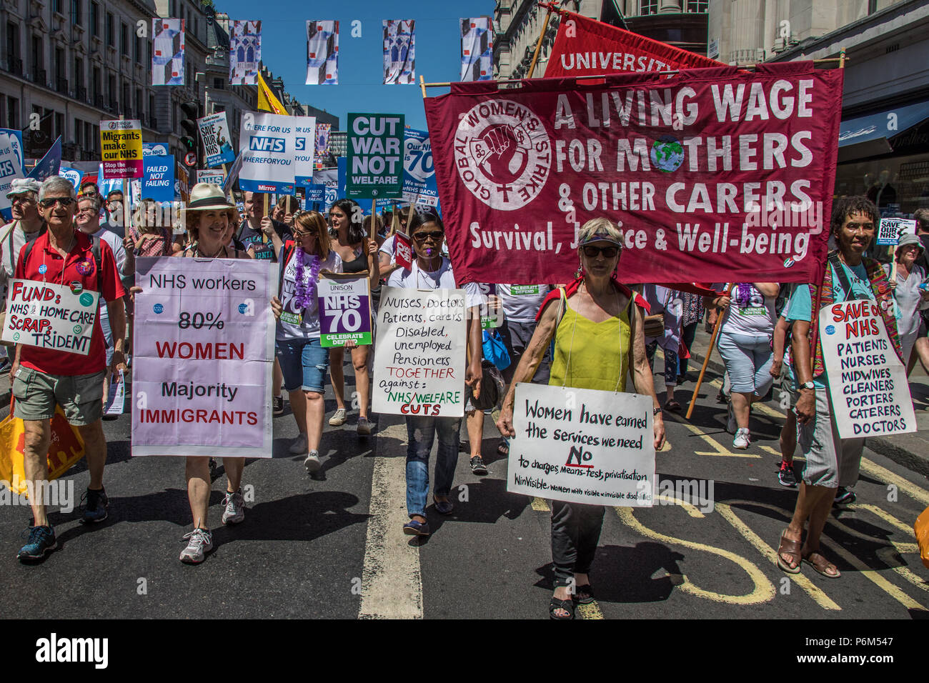 London, UK. 30th Jun, 2018. Global women's strike banner on Regent Street. With the NHS 70 years old this year, thousands marched through central London in a National rally to show support for the service and to demand more funding from the Government. David Rowe/Alamy Live News Stock Photo