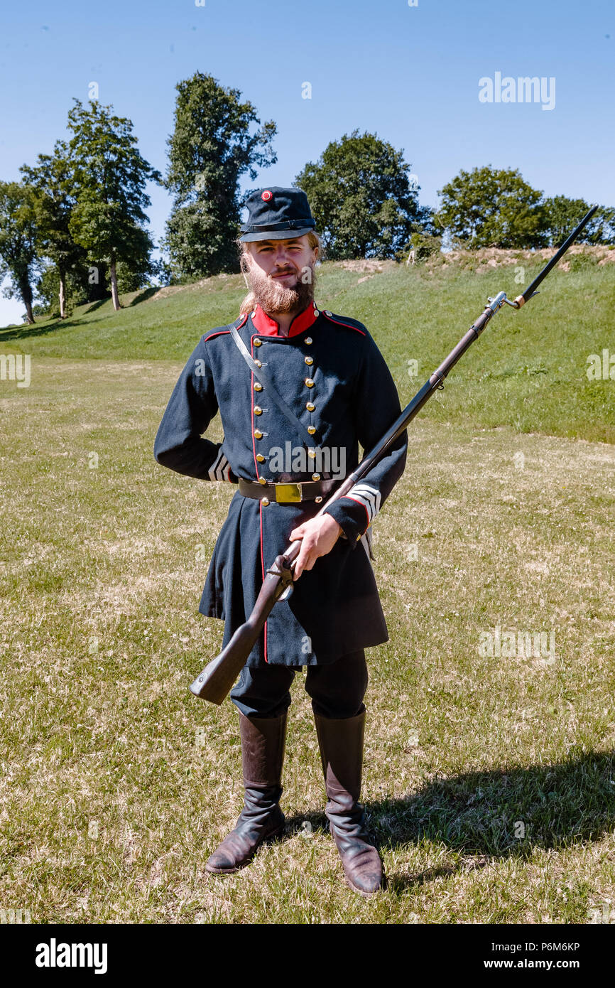 Danewerk, Germany. 01st July, 2018. An employee of the Danevirke Museum is  dressed in a historic Danish military uniform, standing at the medieval  Danish fortification site Danevirke. Danevirke, along with the viking