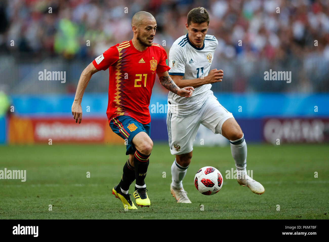 Moscow, Russia. 1st July, 2018. Moscow, Russia. 1st Jul, 2018. David Silva of Spain and Roman Zobnin of Russia during the 2018 FIFA World Cup Round of 16 match between Spain and Russia at Luzhniki Stadium on July 1st 2018 in Moscow, Russia.  Credit: PHC Images/Alamy Live News Credit: PHC Images/Alamy Live News Stock Photo