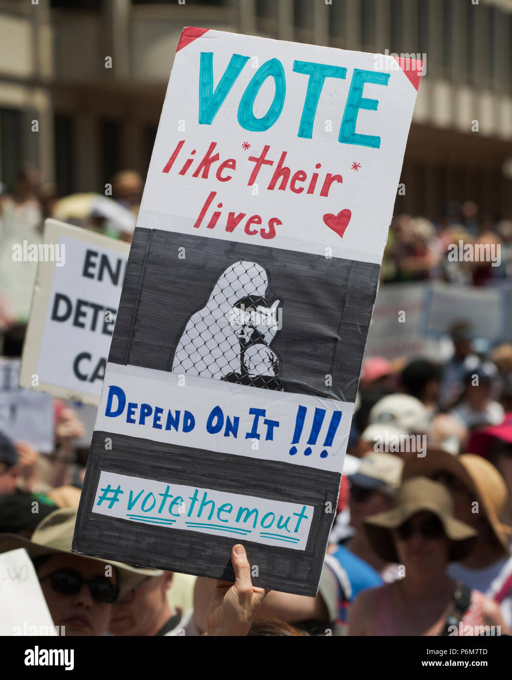 Boston, Massachusetts, USA. 30th June, 2018.  U.S. Demonstrator holding a sign as thousands gathered at City Hall Plaza in Boston, MA, during the Rally against Family Separation by the current United States administration. Rallies against U.S. President Donald Trump’s policy of the detention of immigrants and immigrant families separated by U.S. customs and border agents (I.C.E.) took place in more than 750 US cities on June 30th. Stock Photo