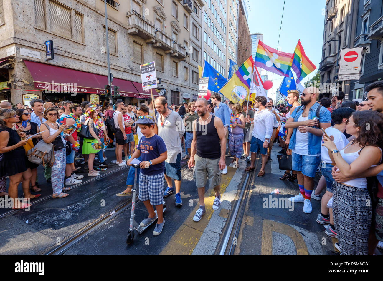 Milan, Italy. 30th Jun, 2018. Political group of people holding peace flags and protesting during the Gay Pride parade. Milan, Italy. June 30, 2018. Credit: Gentian Polovina/Alamy Live News Stock Photo