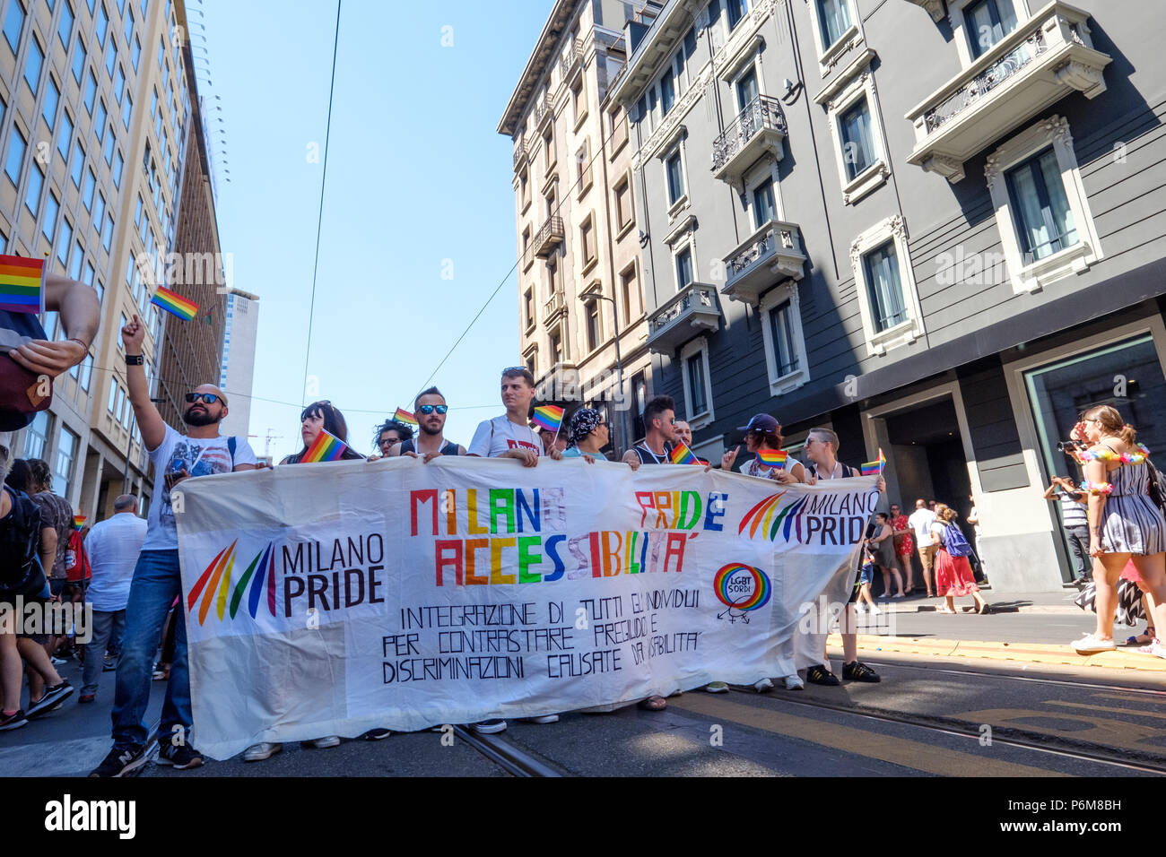 Milan, Italy. 30th Jun, 2018. Milano Pride 2018, manifestation of gay, lesbians, asexuals, bisexuals, intersexual and queer pride. People holding a band during the start of the parade. Milan, Italy. June 30, 2018. Credit: Gentian Polovina/Alamy Live News Stock Photo
