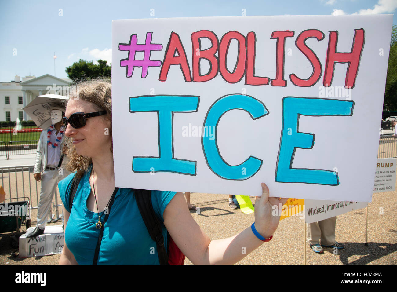 'Abolish ICE' reads the sign. At the 'Families Belong Together March' in Washington, DC, tens of thousands assembled near the White House in Lafayette Park. It was the largest of hundreds of marches taking place on Saturday June 30, 2018 across the United States to demand that the Trump administration reunite families separated at the U.S.-Mexico border. The U.S. Immigration and Customs Enforcement (ICE) is a law enforcement agency of the Federal government of the United States under the jurisdiction of the Department of Homeland Security. (Photo by Jeff Malet) Photo via Newscom Stock Photo