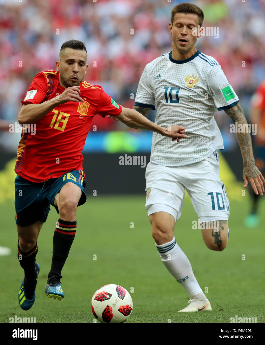 Moscow, Russia. 1st July, 2018. Jordi Alba (L) of Spain vies with Fedor Smolov of Russia during the 2018 FIFA World Cup round of 16 match between Spain and Russia in Moscow, Russia, July 1, 2018. Credit: Yang Lei/Xinhua/Alamy Live News Stock Photo