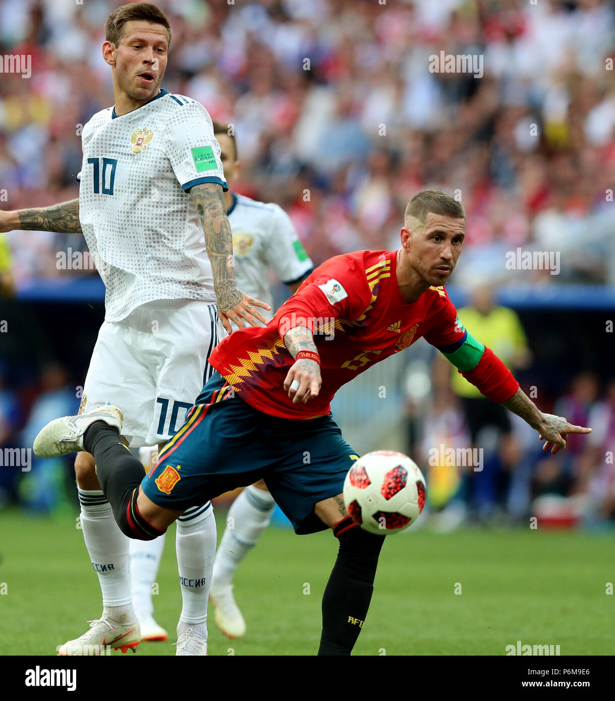 Moscow, Russia. 1st July, 2018. Sergio Ramos (R) of Spain vies with Fedor Smolov of Russia during the 2018 FIFA World Cup round of 16 match between Spain and Russia in Moscow, Russia, July 1, 2018. Credit: Yang Lei/Xinhua/Alamy Live News Stock Photo