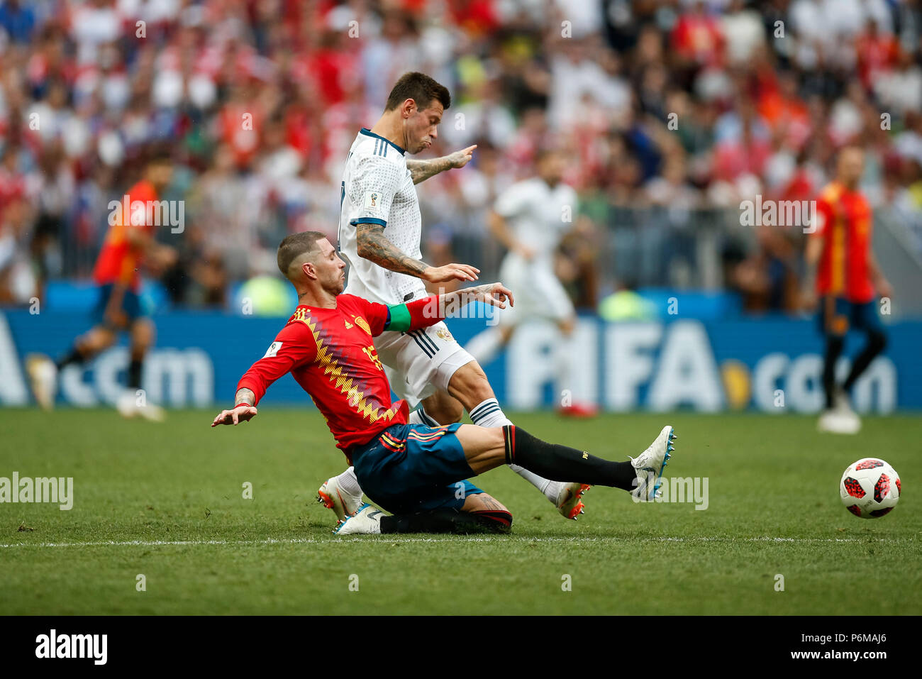 Moscow, Russia. 1st July, 2018. Fedor Smolov of Russia is tackled by Sergio Ramos of Spain during the 2018 FIFA World Cup Round of 16 match between Spain and Russia at Luzhniki Stadium on July 1st 2018 in Moscow, Russia. Credit: PHC Images/Alamy Live News Stock Photo