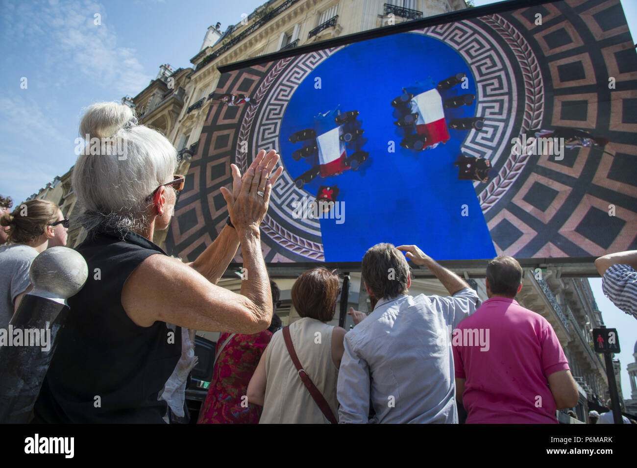 Paris, Ile de France, France. 1st July, 2018. People are seen watching the burial ceremony on a huge screen.Burial ceremony at the Pantheon of former French politician and Holocaust survivor Simone Veil and her husband Antoine Veil in Paris. Former Health Minister, Simone Veil, who passed away on June 30, 2017 became president of the European Parliament and one of France's most revered politicians by advocating the 1975 law legalizing abortion in France. Credit: Thierry Le Fouille/SOPA Images/ZUMA Wire/Alamy Live News Stock Photo