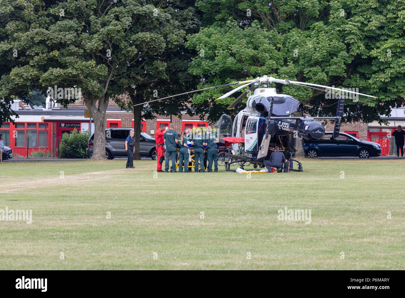 Worthing, Sussex, UK; 1st July 2018; Ambulance Service Staff place a casualty in an Air Ambulance after incident at Victoria Park. Credit: Ian Stewart/Alamy Live News Stock Photo
