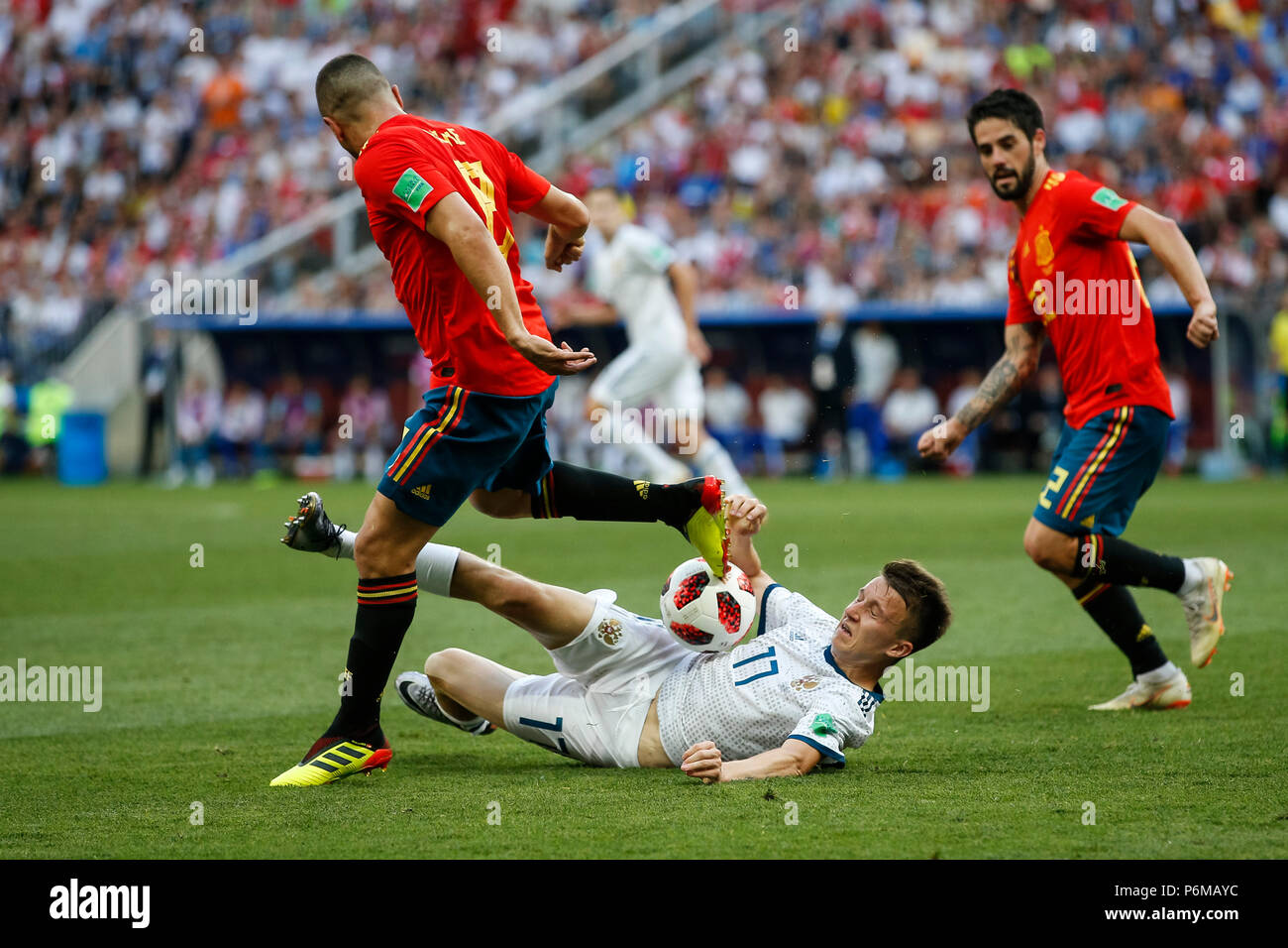 Moscow, Russia. 1st July, 2018. Koke of Spain is tackled by Aleksandr Golovin of Russia during the 2018 FIFA World Cup Round of 16 match between Spain and Russia at Luzhniki Stadium on July 1st 2018 in Moscow, Russia. Credit: PHC Images/Alamy Live News Stock Photo