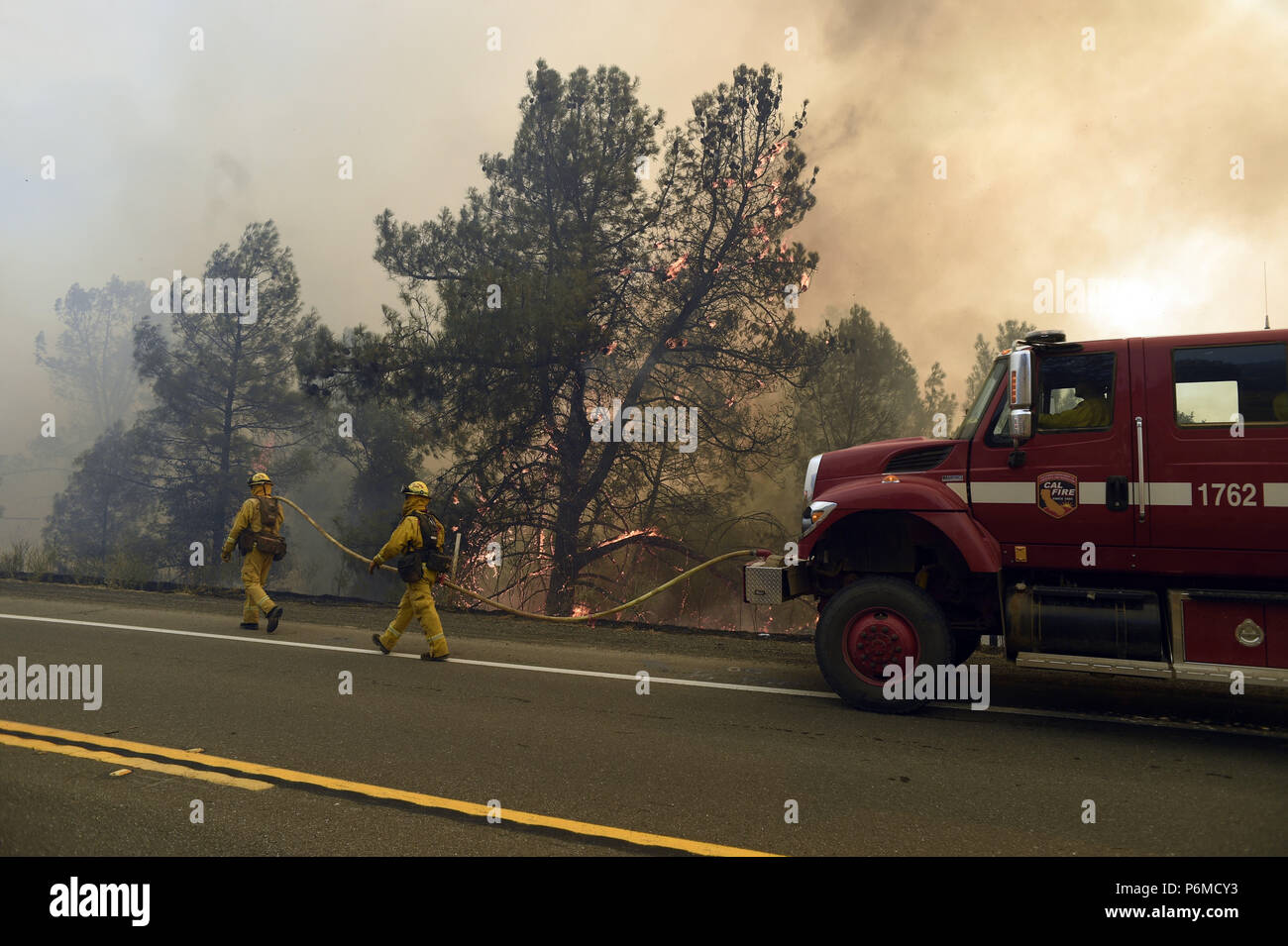 Clearlake Oaks, California, USA. 1st July, 2018. Fire crews worked quickly put out the many spot fires along highway 20 across from the main Pawnee Fire in Lake County. Credit: Neal Waters/ZUMA Wire/Alamy Live News Stock Photo