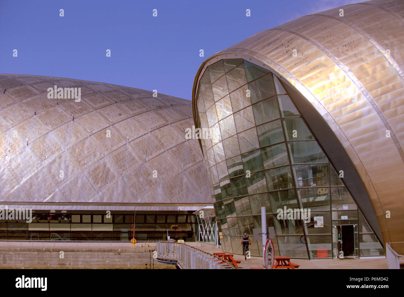 Glasgow, Scotland, UK 1st July. UK Weather:Sunny sizzling weather continues and The weather proof cover on Glasgow Science Centre's roof that melted at the start of the scorching weather, continues to drip, the black drips down the building.It look lovely in the Golden sunlight . Credit: gerard ferry/Alamy Live News Stock Photo