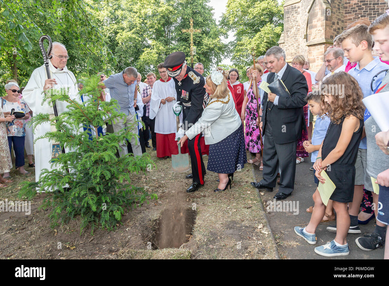 Warrington, UK. 01 July 2018 - The Finale of the Sunday service was taken outside of the church where a yew tree was planted by Cllr Karen Mundry, The Mayor of Warrington, and Thomas David Briggs, MBE, KstJ, Lord Lieutenant of Cheshire whilst the service and prayers were  held by Reverend Michael Ridley, Vicar of St Thomas' and the Rt Reverend Dr Peter Forster, Bishop of Chester Credit: John Hopkins/Alamy Live News Stock Photo