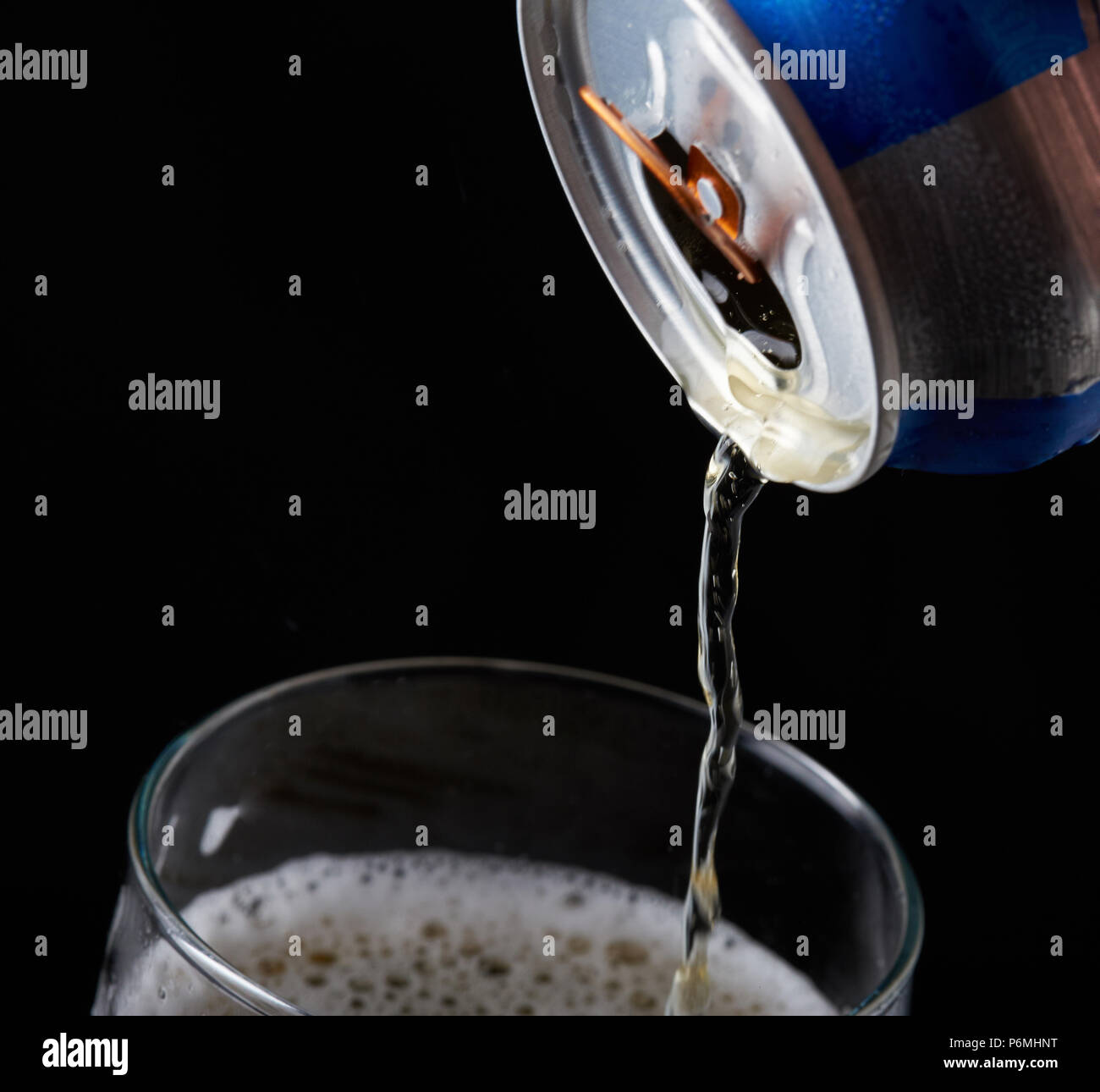 Close-up of pouring beer from metal can in glass Stock Photo