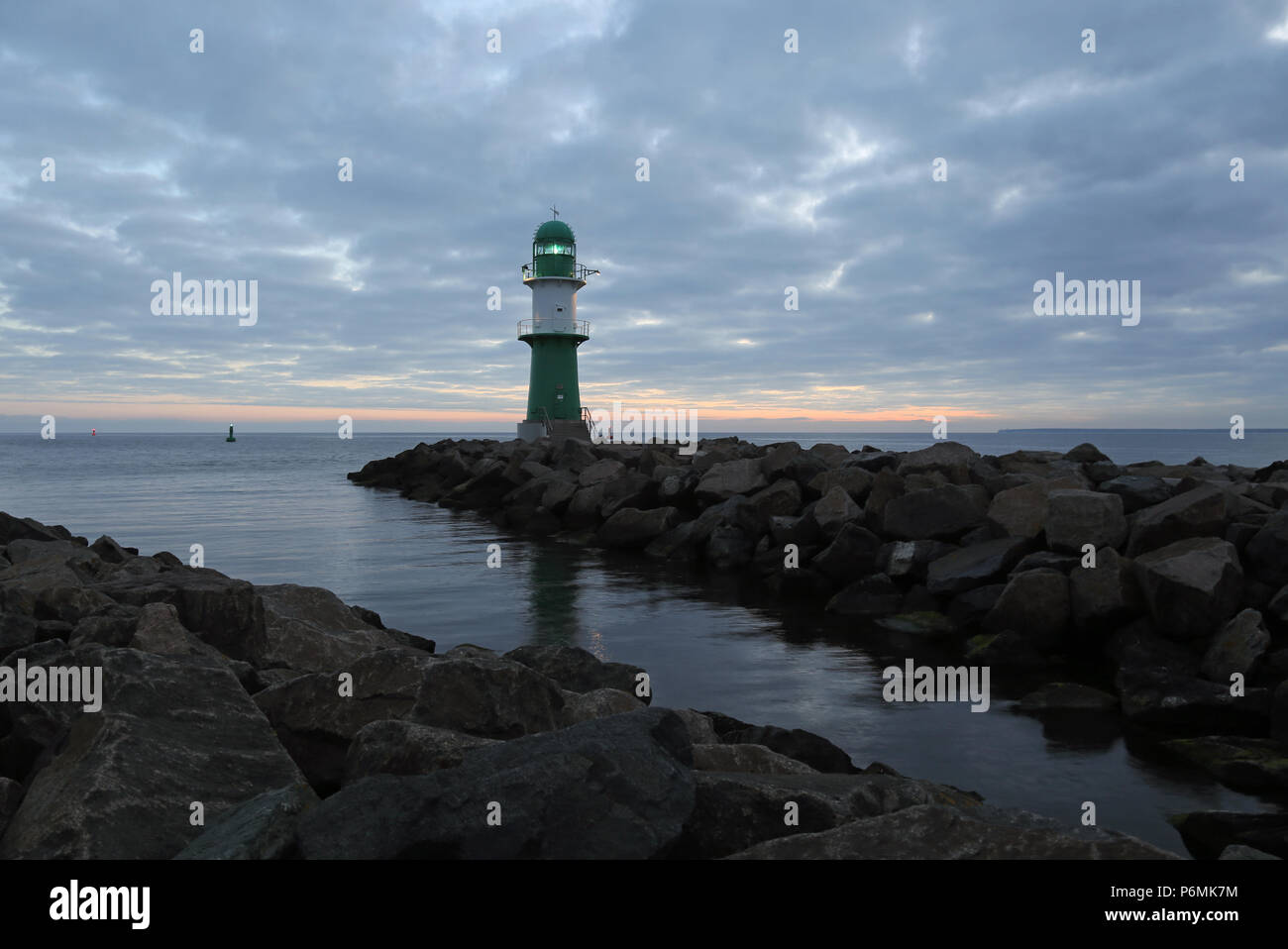 Warnemuende, lighthouse at the Westmole at dusk Stock Photo