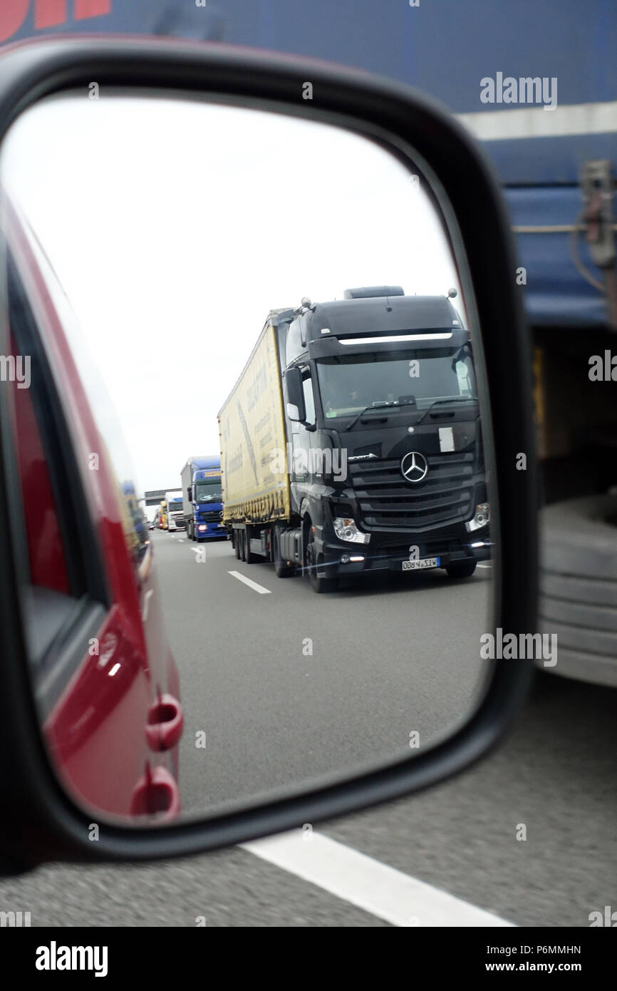 Michendorf, Germany, trucks are reflected in the right side mirror of a car Stock Photo