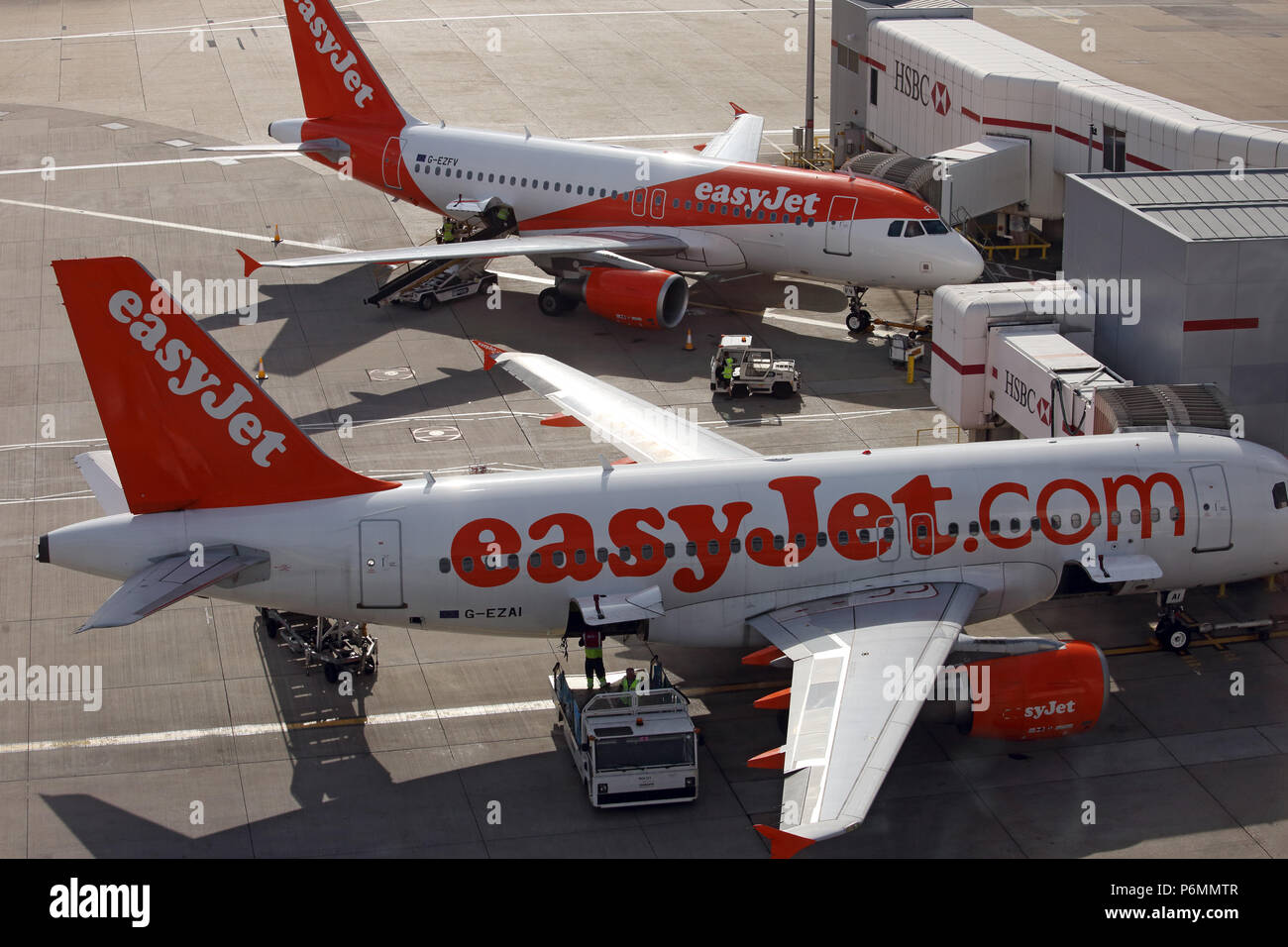 London, United Kingdom, two Airbus A 319 owned by easyJet at the terminal of London Gatwick Airport Stock Photo